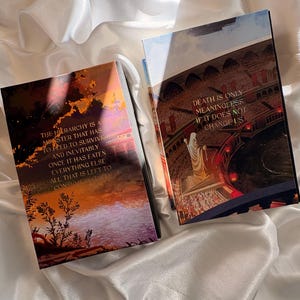 May include: Two hardcover books with fantasy art covers. One features a sunset scene with text: "THE HIERARCHY IS A MONSTER THAT HAS TO FEED TO SURVIVE." The other book shows a crowd scene with text: "DEATH IS ONLY MEANINGLESS IF IT DOES NOT CHANGE US."