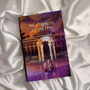 May include: A hardcover book titled "The Strength of the Few" with an illustration of two figures in a body of water in front of a building with columns. The cover art features a color palette of purple, orange, and gold.