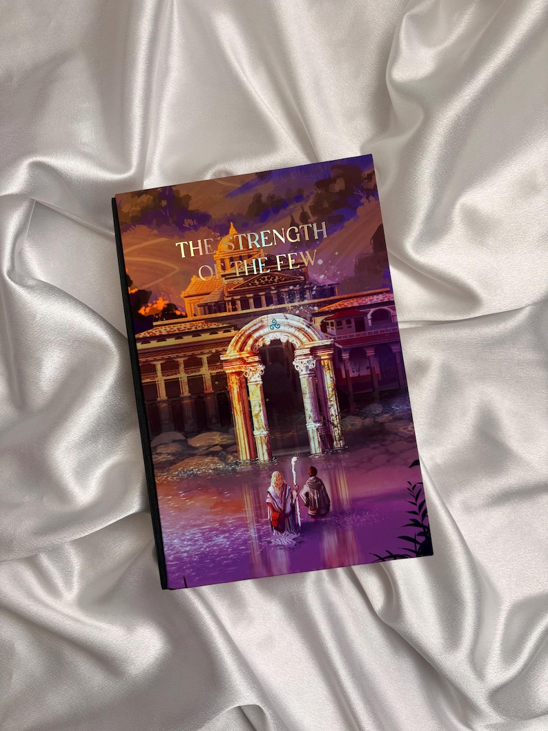 May include: A hardcover book titled "The Strength of the Few" with an illustration of two figures in a body of water in front of a building with columns. The cover art features a color palette of purple, orange, and gold.