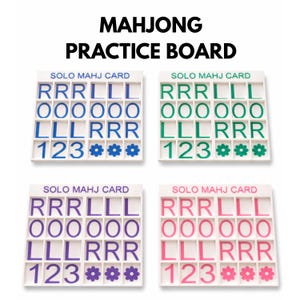 May include: A white ceramic mug with a black handle and the text "But First, Coffee" in a bold, black font. The mug is set against a blurred background, suggesting a cozy setting.