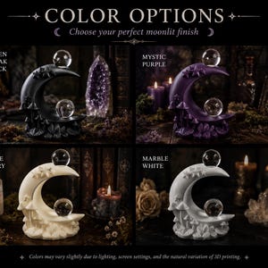 May include: A crescent moon sculpture featuring small stars and mushrooms at the base, topped with two clear glass spheres. The sculpture is available in four colors: Raven Cloak Black, Mystic Purple, Bone Ivory, and Marble White.