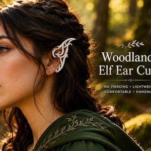 May include: A white, intricate, swirling ear cuff worn on the outer ear. The text on the right reads: Woodland Elf Ear Cuffs, NO PIERCING, LIGHTWEIGHT, COMFORTABLE, HANDMADE. The design features organic, curved lines that mimic an elongated ear shape.