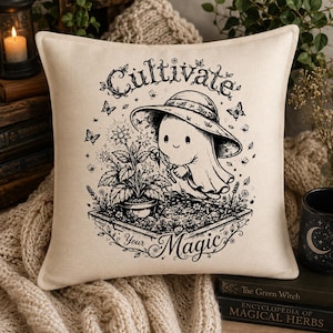 May include: A square off-white throw cushion featuring a black line art illustration of a ghost wearing a wide-brimmed hat, gardening a potted plant. The text reads Cultivate Your Magic, surrounded by small flowers, butterflies, and bees.