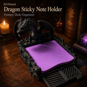 May include: A 3D-printed black dragon sticky note holder with a fantasy theme. The dragon is perched atop a textured base, holding a stack of purple sticky notes. The text "Dragon Sticky Note Holder" and "Fantasy Desk Organizer" are visible.