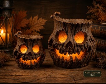 May include: Two brown, textured, tree-stump-shaped candle holders with carved, glowing jack-o'-lantern faces. The larger one features a label that reads NEW MEDIUM SIZE. Both items have a rough, bark-like exterior and emit a warm, orange light.