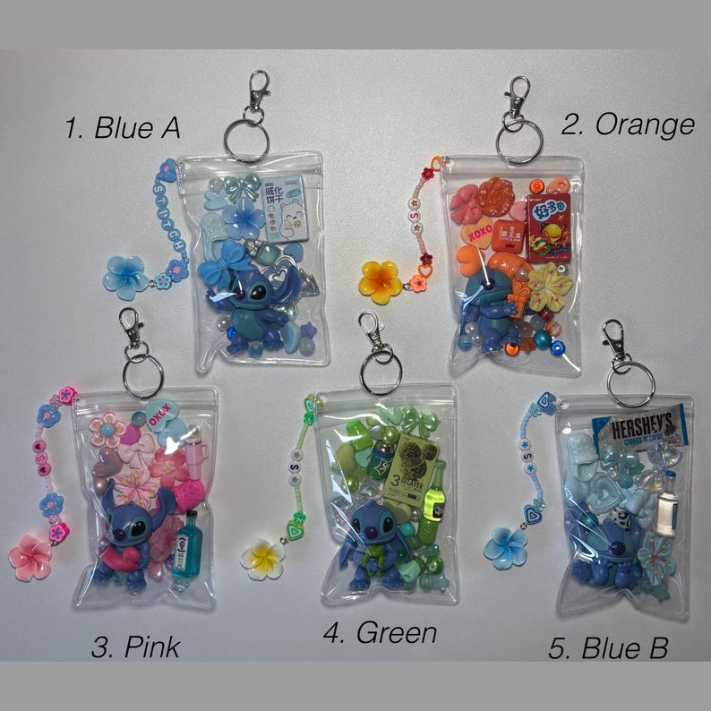 May include: Five clear zipper pouches with keychains, each filled with colorful beads, charms, and a Stitch figurine. The pouches are labeled: Blue A, Orange, Pink, Green, and Blue B. Each pouch has a beaded charm strap.