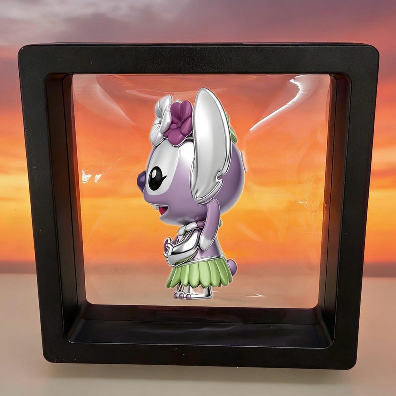 May include: A purple and silver character figurine with large ears, wearing a green grass-style skirt and a purple flower accessory on its head, suspended inside a square black floating display frame with a clear plastic membrane.