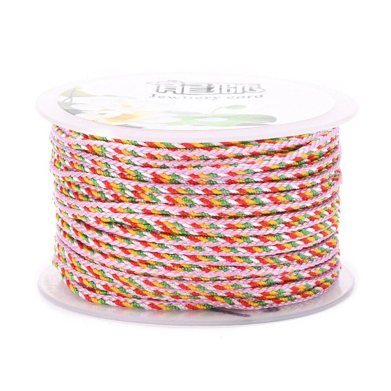 May include: A spool of multi-colored braided cord, featuring pink, red, yellow, and green stripes. The cord is wound around a white plastic spool with the text "Jewellery Cord" printed on the label.