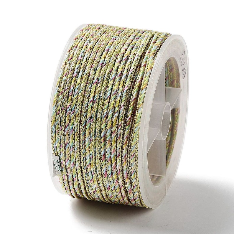May include: A spool of multi-colored braided cord. The cord is primarily a light green color with interwoven strands of yellow, pink, and blue. The cord is tightly wound on a clear plastic spool, suitable for crafts and jewelry making.