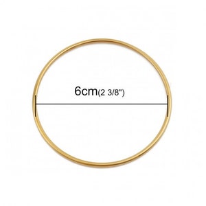 May include: A gold-colored bangle bracelet with a diameter of 6 cm (2 3/8 inches).