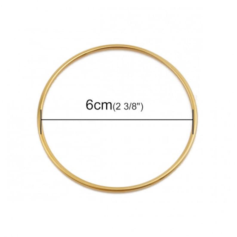 May include: A gold-colored bangle bracelet with a diameter of 6 cm (2 3/8 inches).