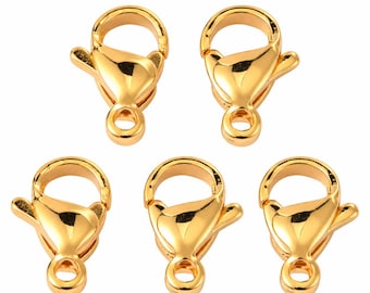 May include: Five gold-toned metal lobster claw clasps arranged in a pattern. Each clasp features a smooth, reflective surface, a spring-loaded mechanism, and a circular loop at the base for attachment to jewellery or other craft projects.