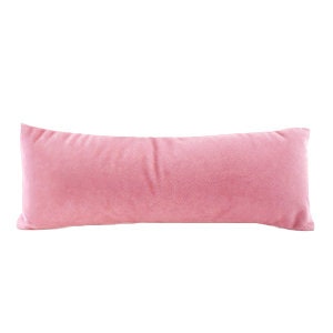 May include: A long, rectangular pink velvet pillow.