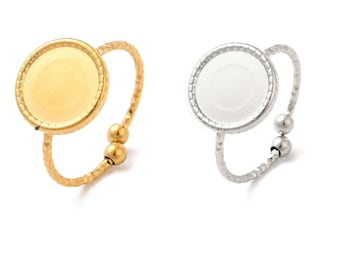 May include: Two adjustable rings with round, bezel-set, blank, circular, metal,  cabochons. The ring on the left is gold, and the ring on the right is silver.