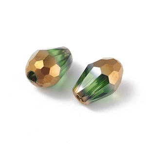 May include: Two green and gold teardrop-shaped glass beads with a faceted design.