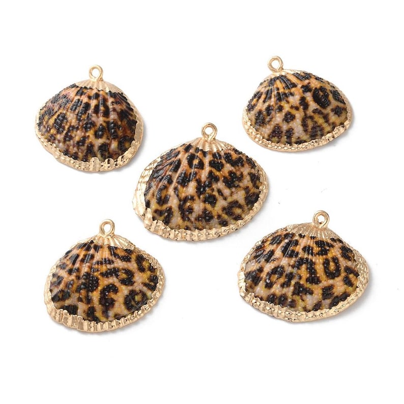 May include: Five gold-toned shell charms with a leopard print design. The shells are about 1.5 inches in diameter.