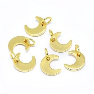 May include: Six gold-colored crescent moon charms with jump rings. The charms are perfect for jewelry making or adding a touch of whimsy to crafts.