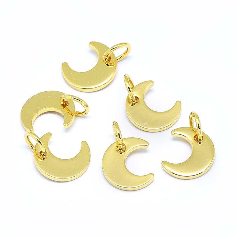 May include: Six gold-colored crescent moon charms with jump rings. The charms are perfect for jewelry making or adding a touch of whimsy to crafts.