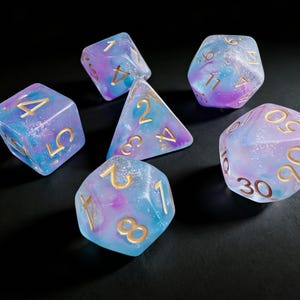 May include: A set of three ceramic mugs with a speckled, matte finish. The mugs are in shades of cream, light gray, and dark gray. Each mug has a simple, minimalist design, perfect for coffee or tea.