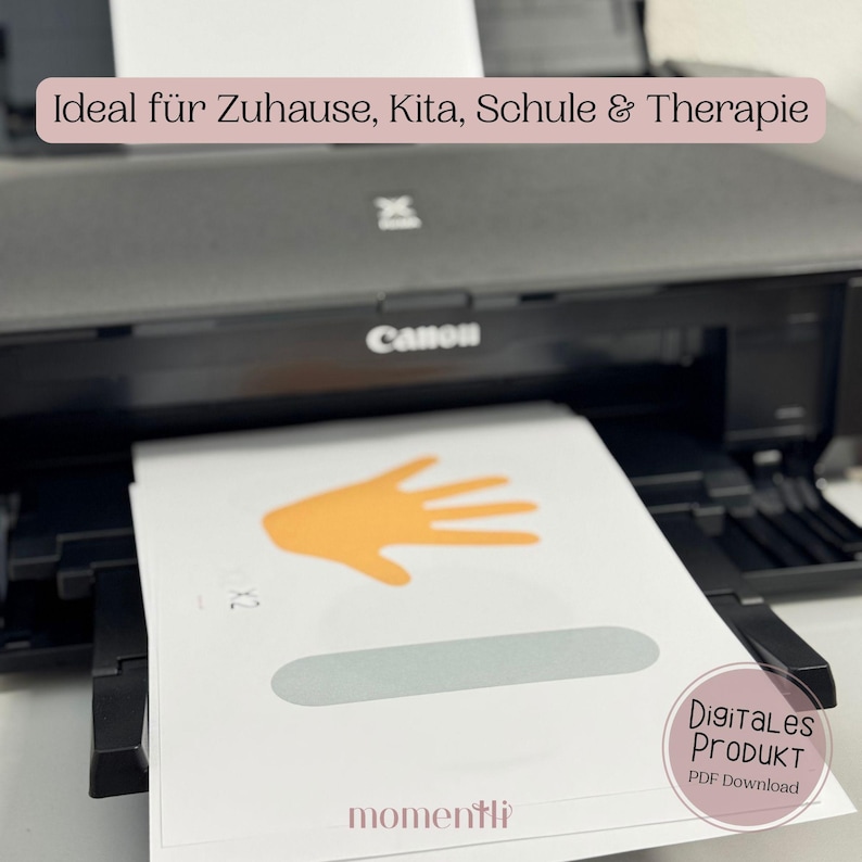 May include: A black Canon printer printing white paper with an orange hand graphic and a gray oval. The text "Digitales Produkt PDF Download" is visible. The text "Ideal f&uuml;r Zuhause, Kita, Schule & Therapie" is also visible.