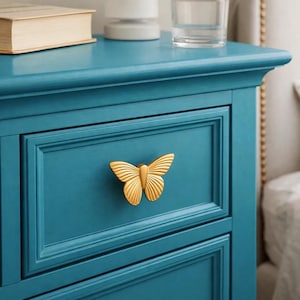 May include: A set of three ceramic mugs with a speckled, matte finish in cream, light grey, and dark grey. Each mug has a minimalist design, ideal for tea or coffee.