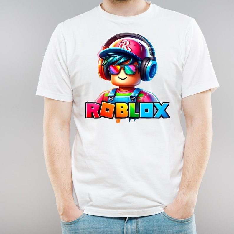 May include: White t-shirt with a vibrant Roblox character graphic. The character wears headphones and sunglasses, with the Roblox logo in rainbow colours below.