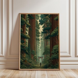 May include: A framed vertical wall art print depicting a dense forest with towering brown tree trunks and lush green foliage. A small figure walks along a path toward a red torii gate positioned in the distance, centered between the trees.