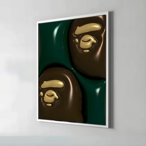 May include: A framed art print featuring a repeating pattern of brown and gold ape head logos against a dark green background. The artwork has a glossy, three-dimensional appearance, with the logos appearing raised from the surface.