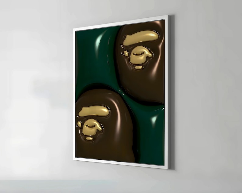 May include: A framed art print featuring a repeating pattern of brown and gold ape head logos against a dark green background. The artwork has a glossy, three-dimensional appearance, with the logos appearing raised from the surface.