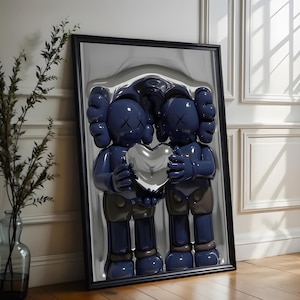 May include: Framed artwork featuring two blue cartoon figures holding a silver heart. The figures have X-shaped eyes and gloved hands. The artwork is in a black frame and leans against a white wall.
