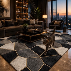 May include: A large area rug featuring a geometric pattern of black, dark gray, and off-white polygons outlined with thin gold lines. The rug has a textured, plush pile and covers a significant portion of the floor in a living room setting.