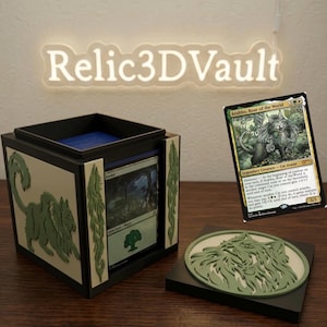 May include: A black square trading card deck box with light green cat-themed relief accents on the sides and a matching circular lid. A Magic: The Gathering card featuring Arahbo, Roar of the World is displayed next to the open box containing a Forest card.