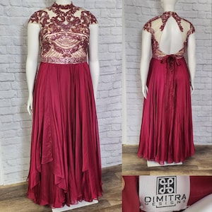 May include: A burgundy floor-length gown with a sequined bodice and a keyhole back. The gown has a ruffled skirt and is labeled "Dimitra Designs".