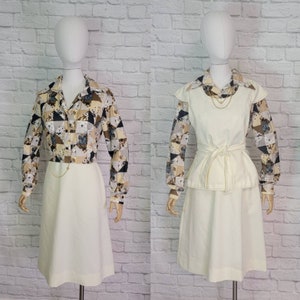 May include: A white dress with a geometric patterned blouse. The dress has a fitted bodice and a full skirt. The blouse has long sleeves and a collar.