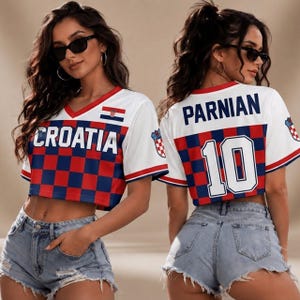 May include: A white cropped jersey featuring a red and blue checkered pattern on the lower half. The front displays the text CROATIA and a small flag. The back features the name PARNIAN and the number 10 in white with blue and red outlines.
