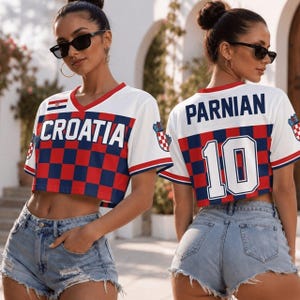 May include: A white, red, and blue cropped V-neck jersey featuring the text CROATIA on the front and PARNIAN 10 on the back. The garment displays a checkered pattern, red trim, and small Croatian flag emblems on the chest and sleeves.
