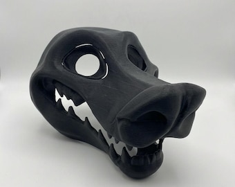 May include: A black, 3D-printed mask shaped like a stylized animal head. It has large eye holes, a prominent snout, and a detailed mouth with teeth. The mask is designed for cosplay or costume use.