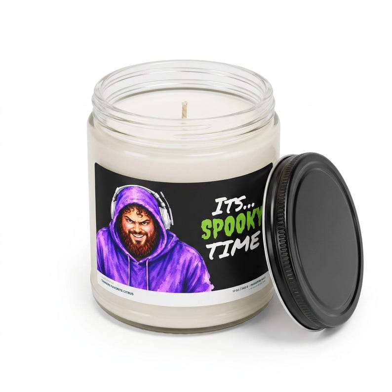 Its Spooky Time candle with the black lid off, showing the white wax and cotton wick