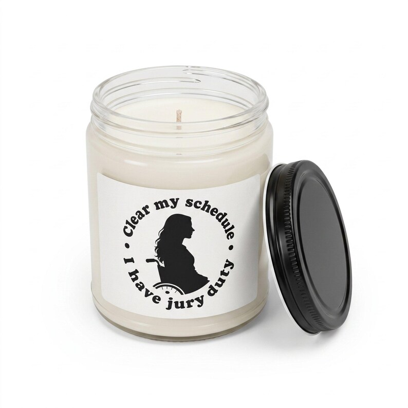 Lindsay Clancy candle with the black lid off, showing the white wax and cotton wick