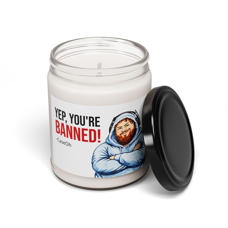 CaseOh Yep You're Banned candle with the black lid off, showing the white wax and cotton wick, on white