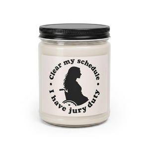 Lindsay Clancy candle, 12 oz paraffin candle in a glass jar with a black lid