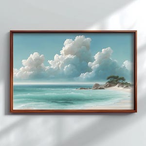 May include: A framed landscape painting depicts a serene beach scene. The artwork features a light blue sky filled with fluffy white clouds. Turquoise waves gently roll onto a sandy shore, with a small island and a tree on the right.