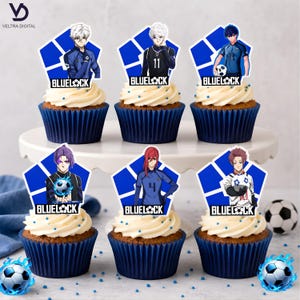 May include: Six cupcakes with white frosting and blue cupcake liners. Each cupcake has a blue and white character topper with the text "BLUELOCK". Soccer balls and blue sprinkles are scattered around the cupcakes.
