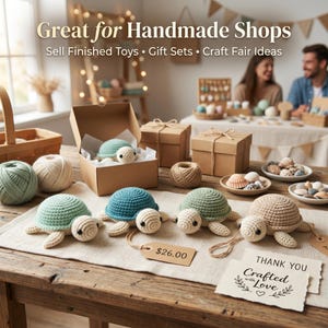 May include: Four crocheted turtle toys in light green, blue, sage green, and beige, each with black eyes. The turtles are displayed on a wooden table with brown gift boxes, yarn balls, seashells, and a tag with the text $26.00 and Thank You Crafted with Love.
