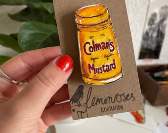 Coleman's mustard brooch