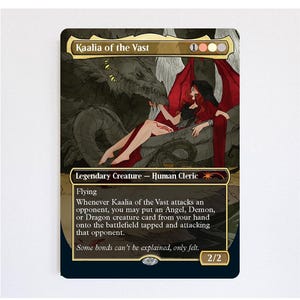 May include: A Magic: The Gathering trading card titled Kaalia of the Vast, featuring a red-haired figure in a red cloak reclining against a large dark dragon. The card text includes Flying, ability details, and the flavour text Some bonds can't be explained, only felt.