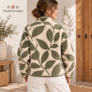 May include: A cream-colored fleece jacket featuring a repeating pattern of dark olive green leaves. The jacket has a high collar, long sleeves, and a textured, fuzzy material. The text FamilySewingCo is visible in the upper left corner.