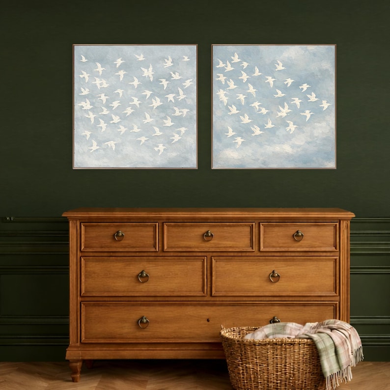 Large framed white birds in flight canvas — lighter sky with soft cloud tones and heart-shaped dove flock formation, impasto texture bird painting, dusty blue bedroom wall art, part of matching set of 2