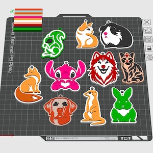 May include: A selection of animal-shaped charms in various colours, including a fox, squirrel, guinea pig, and rabbit. Each charm has a small hole for hanging. The charms are in shades of orange, green, pink, and black.