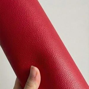 May include: A set of three ceramic mugs with a speckled, cream-colored glaze. Each mug features a different hand-painted floral design in shades of blue, green, and yellow. The mugs have a simple, modern shape.